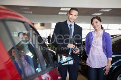 Woman and a salesman standing side by side