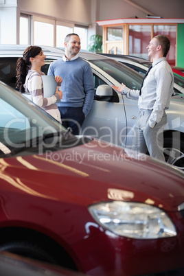 Smiling salesman chatting with customers