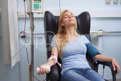 Patient receiving a transfusion while listening music