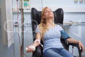 Patient receiving a transfusion while listening music