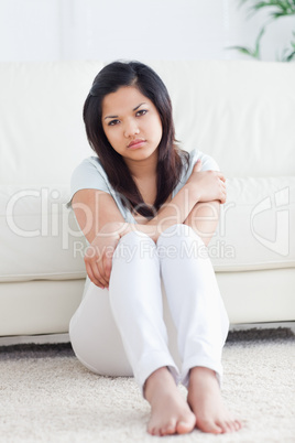 Barefoot woman sitting on the floor