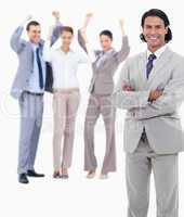 Businessman smiling and crossing his arms with enthusiastic peop