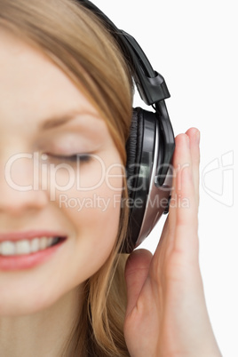 Close up of a woman listening music while smiling