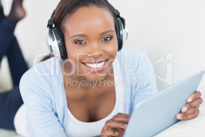 Black woman listening music while looking at camera