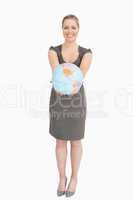 Businesswoman showing a globe