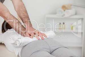 Masseur massaging a woman with a towel