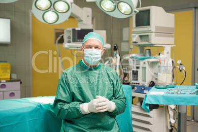 Surgeon smiling while joining his hands together