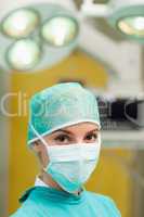 Woman standing and wearing a surgical gear