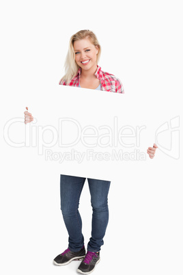 Smiling woman holding a blank placard