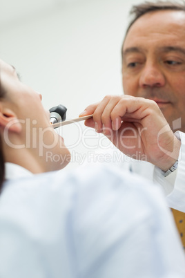 Doctor auscultating the mouth of a patient