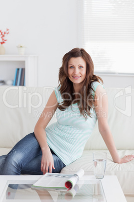 Woman sitting on a sofa while looking at camera