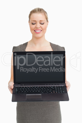 Woman showing a laptop screen