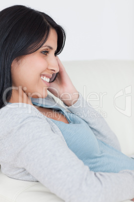 Woman holding a phone next to her ear