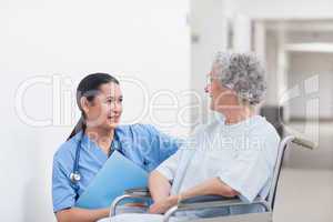Nurse next to a patient in a wheelchair