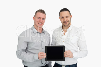 Two smiling men holding a tablet computer