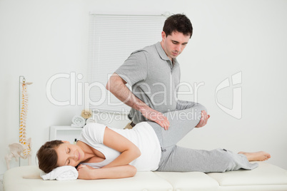 Leg of a woman being manipulated by a chiropractor