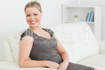 Smiling woman sitting on a sofa