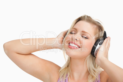 Woman listening to music while closing her eyes