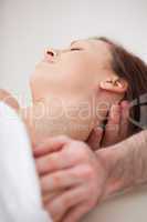 Close-up of neck of woman beig manipulating by a therapist