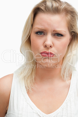 Upset blonde woman seriously looking at the camera