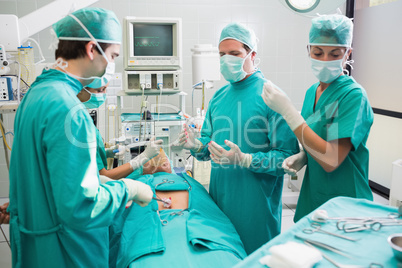 Surgery team operating a patient in an operating theater