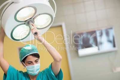 Woman holding a surgical light
