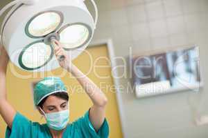 Woman holding a surgical light
