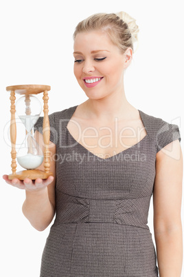 Woman looking a hourglass on her hand