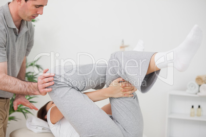 Woman doing her exercise while being helped