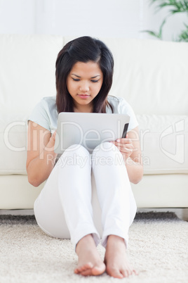 Woman sitting in front of a couch while playing with a tactile t