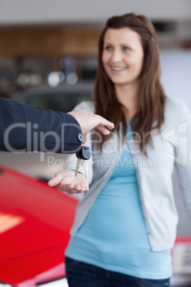 Brunette receiving car keys in his hand