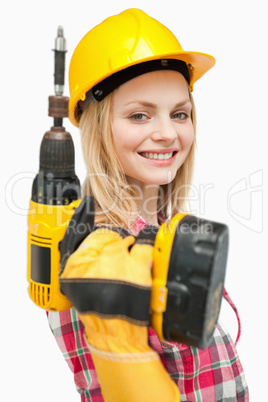Smiling woman holding an electric screwdriver