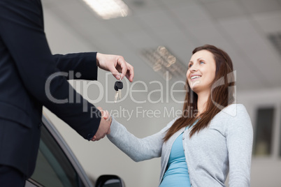 Client receiving car keys while shaking hand