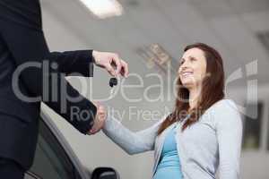 Client receiving car keys while shaking hand