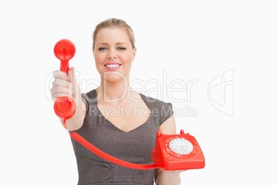 Smiling woman showing a retro phone