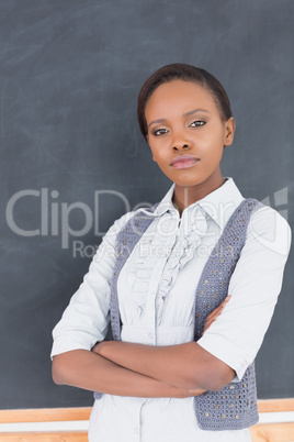 Serious teacher looking at camera with arms crossed