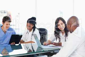 Medical team working on both a laptop and a clipboard