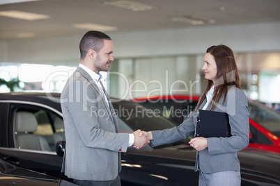 Businesswoman shaking hand of a man