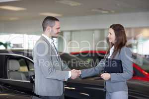 Businesswoman shaking hand of a man