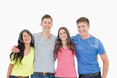 A laughing group of friends look at the camera