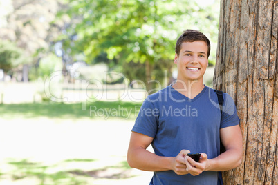 Portrait of a muscled young man with a smartphone