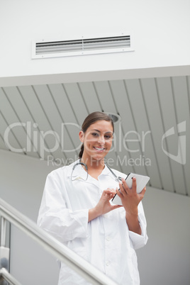 Smiling female doctor using a tablet computer Smiling female doctor using a tablet computer