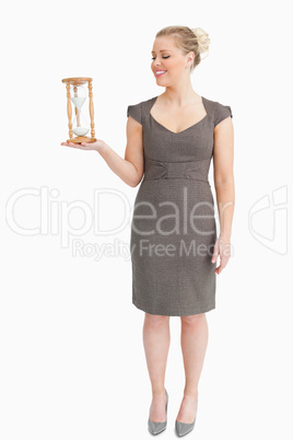 Woman holding in her hand a hourglass
