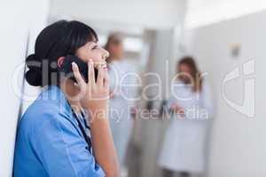 Smiling nurse holding a mobile phone