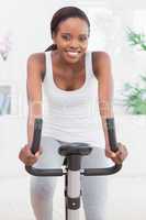 Black woman doing exercise bike