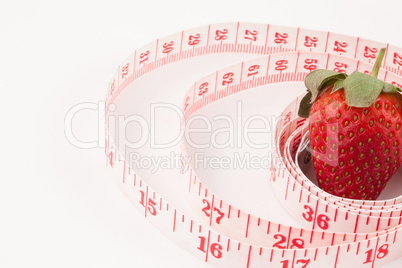 Close up of a strawberry surrounded by a ruler