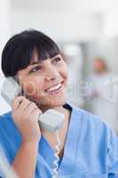 Smiling nurse holding a phone