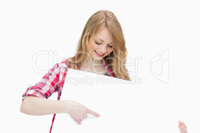 Woman looking at a blank board while showing it