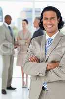 Young businessman standing upright while crossing his arms