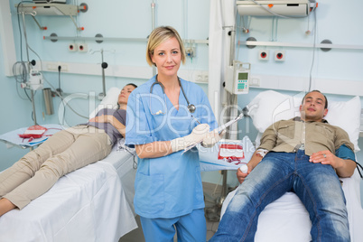 Transfused patients lying next to a nurse